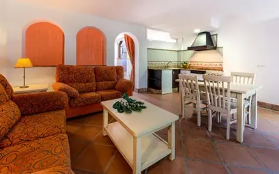 a living room with a couch and a table at Hacienda Roche Viejo in Conil de la Frontera