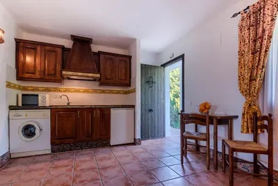 a kitchen with a sink and a dishwasher at Hacienda Roche Viejo in Conil de la Frontera