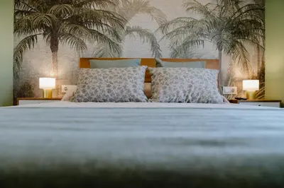 a bedroom with a large bed with two lamps at Apartamento The River in El Puerto de Santa María