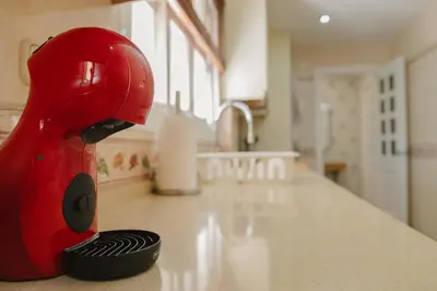 a red mixer sitting on top of a kitchen counter at Apartamento The River in El Puerto de Santa María