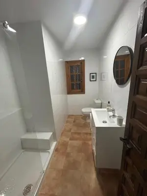 a white bathroom with a sink and a toilet at Pinos Verdes in Chiclana de la Frontera