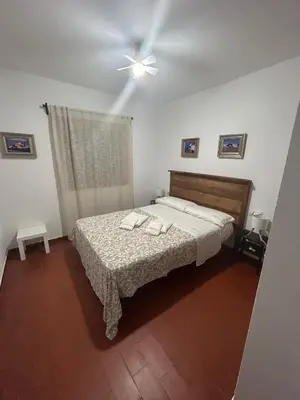 a bedroom with a bed with two towels on it at Pinos Verdes in Chiclana de la Frontera