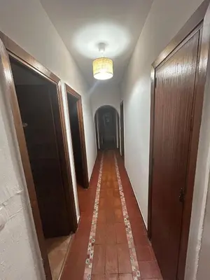 a hallway with a long corridor with a long floor and a ceiling at Pinos Verdes in Chiclana de la Frontera