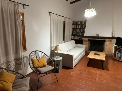 a living room with a couch and a fireplace at Pinos Verdes in Chiclana de la Frontera
