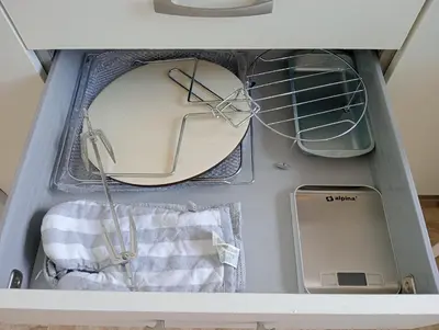a drawer full of appliances in a cabinet at Apartamento Maracaibo in Novo Sancti Petri