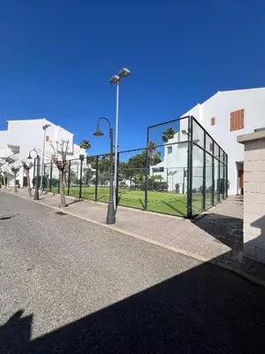 a street with a building with a glass wall at Apartamento Maracaibo in Novo Sancti Petri