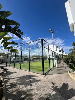 a metal fence with a park in the background at Apartamento Maracaibo in Novo Sancti Petri