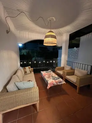 a living room with two couches and a chandelier at Charming house Costa Ballena in Rota