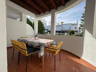 a table and chairs on a patio with a view at Charming house Costa Ballena in Rota