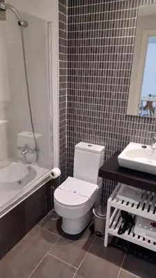 a bathroom with a white toilet and a sink at Apartamento Nuevo Céntrico El Puerto de Santa María in El Puerto de Santa María