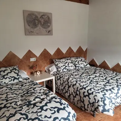 a bedroom with two beds and a nightstand with two beds at El SITIO DE MI RECREO in El Puerto de Santa María