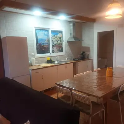 a kitchen with a wooden table and a table and chairs at El SITIO DE MI RECREO in El Puerto de Santa María