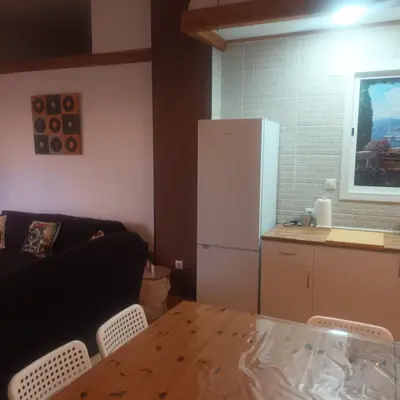 a kitchen with a table and a white refrigerator at El SITIO DE MI RECREO in El Puerto de Santa María