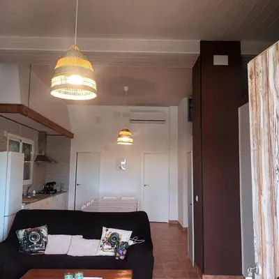 a living room with a black couch and a kitchen at El SITIO DE MI RECREO in El Puerto de Santa María