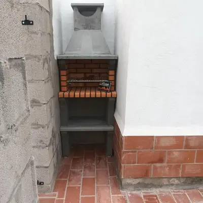 a brick oven sitting in the corner of a building at El SITIO DE MI RECREO in El Puerto de Santa María