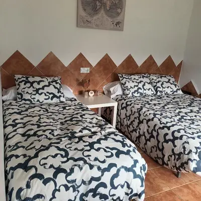 two beds sitting next to each other in a bedroom at El SITIO DE MI RECREO in El Puerto de Santa María
