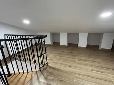 an empty room with a staircase and wooden floors at Cozy Duplex 2 Bedrooms Apart - 200m to La Barrosa Beach in Novo Sancti Petri