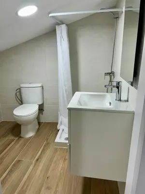 a white bathroom with a toilet and a sink at Cozy Duplex 2 Bedrooms Apart - 200m to La Barrosa Beach in Novo Sancti Petri