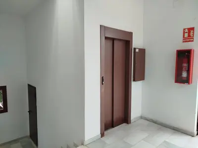 a corridor with two doors in a building at Cozy Duplex 2 Bedrooms Apart - 200m to La Barrosa Beach in Novo Sancti Petri