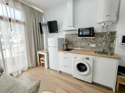 a kitchen with a washing machine and a sink at Cozy Duplex 2 Bedrooms Apart - 200m to La Barrosa Beach in Novo Sancti Petri
