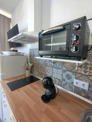 a microwave on top of a counter in a kitchen at Cozy Duplex 2 Bedrooms Apart - 200m to La Barrosa Beach in Novo Sancti Petri
