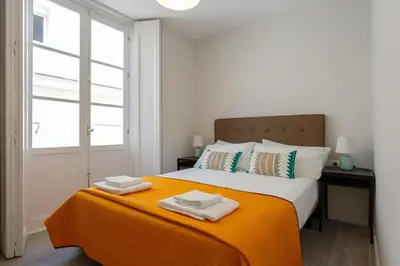 a bedroom with a bed with two towels on it at Apartamento San Jose Grupo AC Gestion in Cádiz