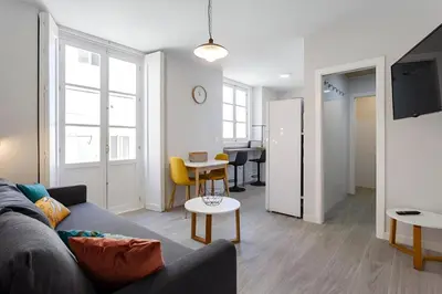 a living room with a couch and a table at Apartamento San Jose Grupo AC Gestion in Cádiz