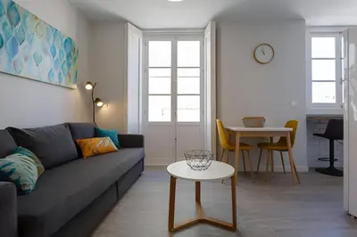 a living room with a couch and a table at Apartamento San Jose Grupo AC Gestion in Cádiz