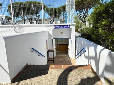 a stairway leading into a baseball dugout at La Almadraba segunda Pista in Chiclana de la Frontera