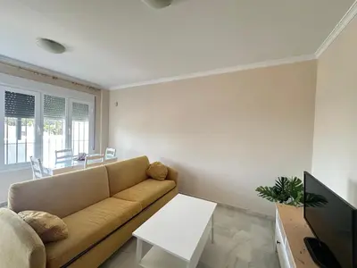 a living room with a couch and a table at La Almadraba segunda Pista in Chiclana de la Frontera