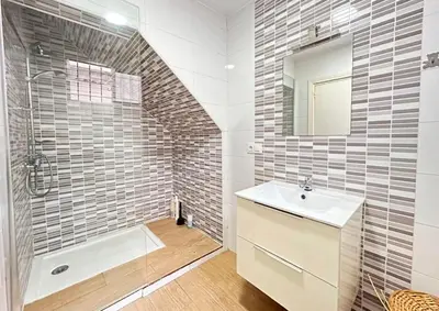 a bathroom with a sink and a shower and a mirror at Sueños de Santiago in Jerez de la Frontera