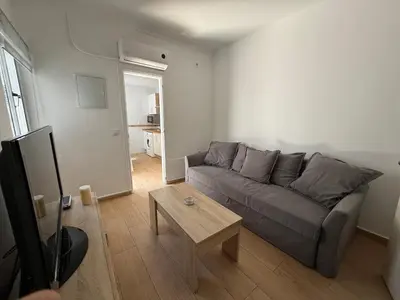 a living room with a couch and a table at Sueños de Santiago in Jerez de la Frontera