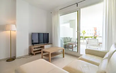 a living room with a couch and a flat screen tv at Beautiful Apartment In Chipiona in Chipiona