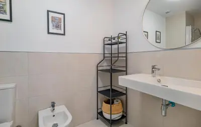 a bathroom with a sink and a toilet and a mirror at Beautiful Apartment In Chipiona in Chipiona
