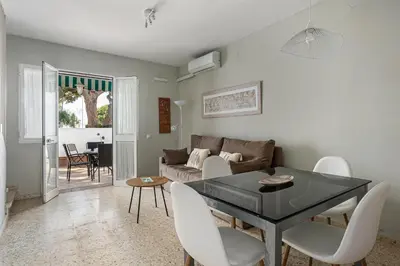 a living room with a table and chairs and a couch at Arenas 65 in Chiclana de la Frontera