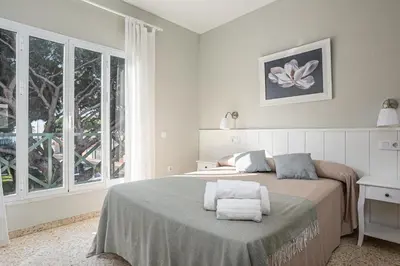 a bedroom with a bed with towels on it at Arenas 65 in Chiclana de la Frontera