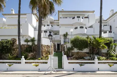 a hotel room with two beds and a window at Complejo Atlantico in Chiclana de la Frontera
