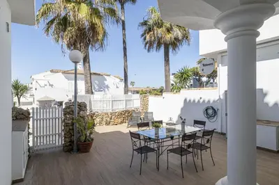 a living room with two couches and a table at Complejo Atlantico in Chiclana de la Frontera