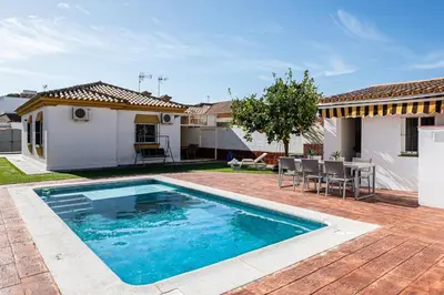 a swimming pool in the backyard of a house at MESANA in Chiclana de la Frontera
