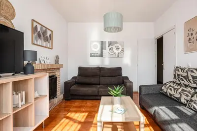 a living room with a couch and a tv at MESANA in Chiclana de la Frontera