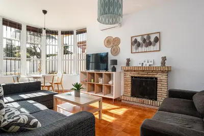 a living room with two couches and a fireplace at MESANA in Chiclana de la Frontera