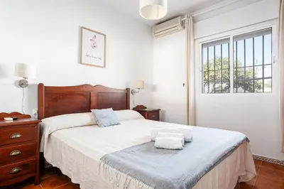 a bedroom with a bed with two towels on it at MESANA in Chiclana de la Frontera