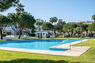 a swimming pool in front of a building at carrajolilla 7B 13 in Chiclana de la Frontera