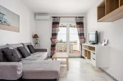 a living room with a couch and a tv at Laja Bermeja in Chiclana de la Frontera