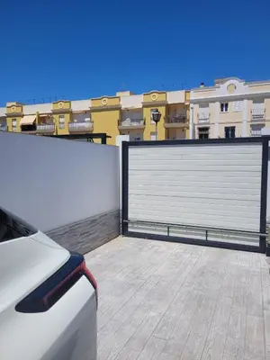 a white garage door on the roof of a building at Casa Nao Santiago - Sanlúcar de Barrameda - Centro Playa in Sanlúcar de Barrameda