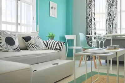 a living room with a couch and a table at Casa Nao Santiago - Sanlúcar de Barrameda - Centro Playa in Sanlúcar de Barrameda