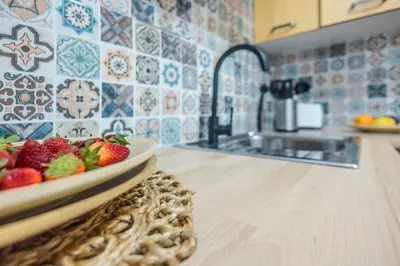 a plate of strawberries on a counter in a kitchen at Cadizz Entre Cielo y Mar Centro del Puerto ciudad - ideal empresas, familias y grupos in El Puerto de Santa María