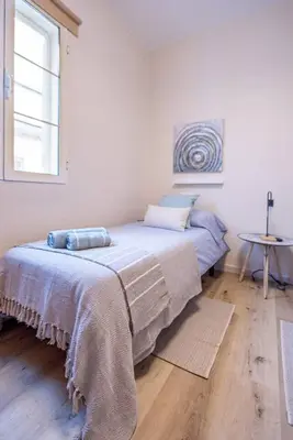 a bedroom with a bed with a blanket on it at Cadizz Entre Cielo y Mar Centro del Puerto ciudad - ideal empresas, familias y grupos in El Puerto de Santa María