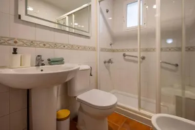 a bathroom with a toilet and a sink and a shower at Cadizz Entre Cielo y Mar Centro del Puerto ciudad - ideal empresas, familias y grupos in El Puerto de Santa María