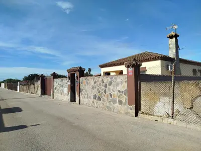 a fence on the side of a road next to a building at Chalet Jones in Chiclana de la Frontera
